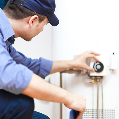 A London HVAC technician maintaining a hot water heater