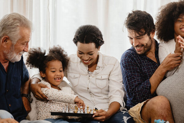 A family sitting together after calling Comfort Zone for air conditioner maintenance