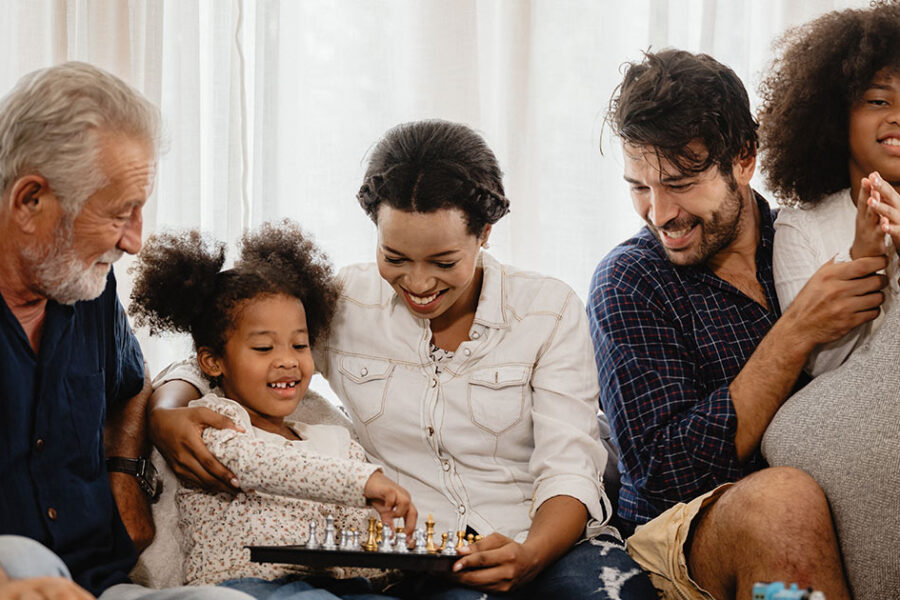 A family sitting together after calling Comfort Zone for air conditioner maintenance