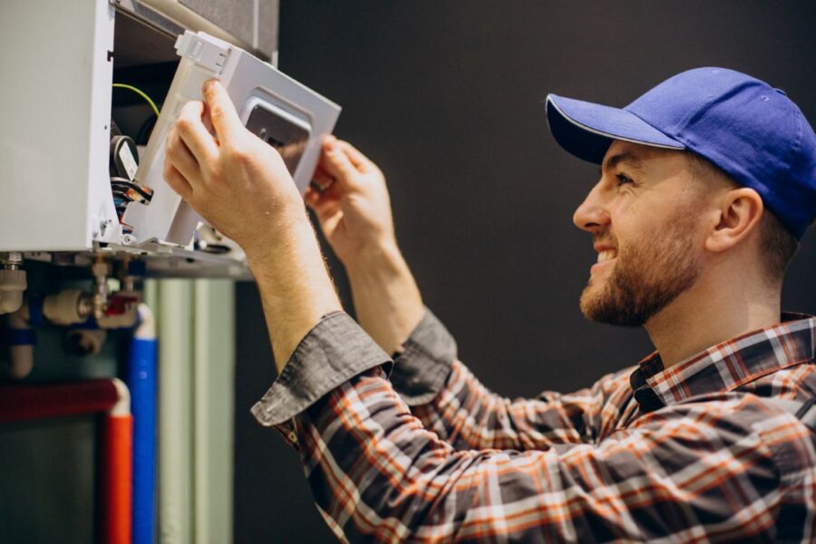 A technician inspecting a furnace smell and repairing it after burning smell from the furnace